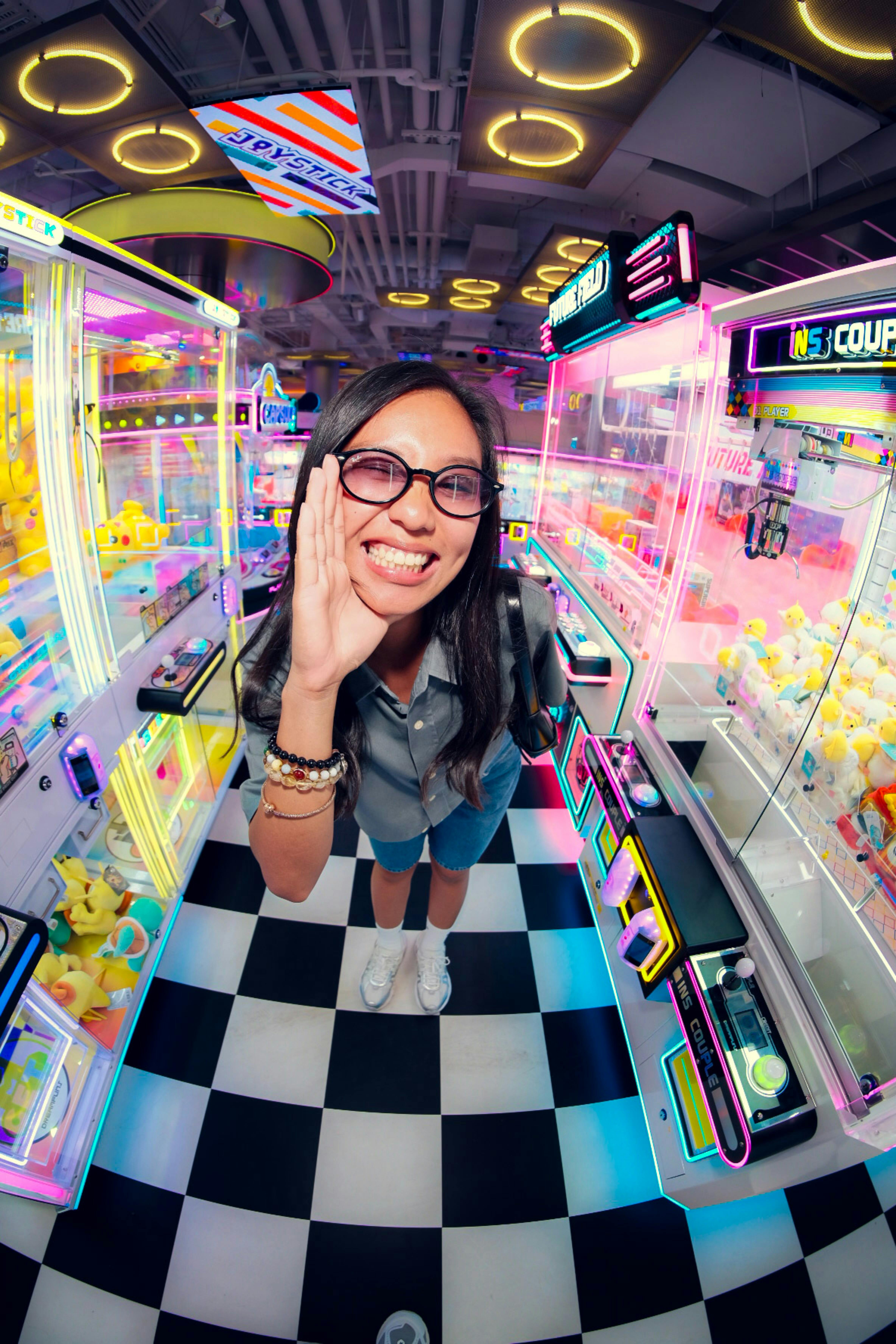 Happy customer in a neon claw machine arcade