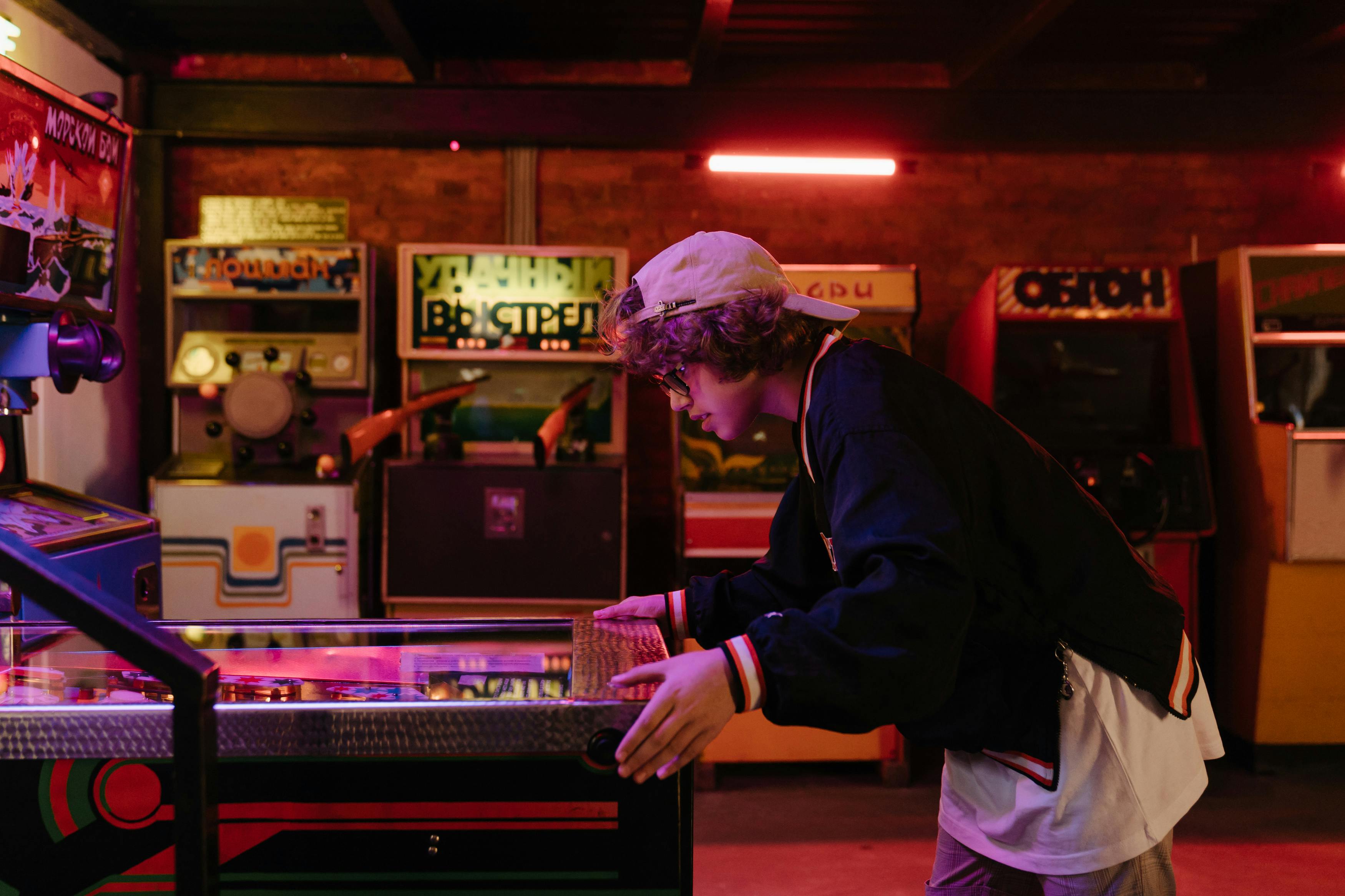 Teen playing a claw machine arcade game